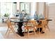 Dining room with dark brown table and six light wood chairs at 9576 Vibrant Lane, Venice, FL 34292