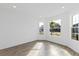 Bright living room featuring a bay window providing ample natural light at 9576 Vibrant Lane, Venice, FL 34292