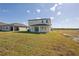 Large backyard with covered patio and grassy area at 101 Runaway Field Ave, Nokomis, FL 34275