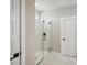 Modern bathroom with a frameless glass shower and marble tile at 101 Runaway Field Ave, Nokomis, FL 34275