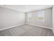 Upstairs bedroom with carpet and two windows at 101 Runaway Field Ave, Nokomis, FL 34275