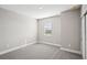 Spacious bedroom with carpeted floor and a window with blinds at 101 Runaway Field Ave, Nokomis, FL 34275