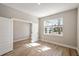 Bright bedroom with large window and wood-look tile floors at 101 Runaway Field Ave, Nokomis, FL 34275