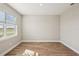 Bright bedroom with large window and wood-look tile floors at 101 Runaway Field Ave, Nokomis, FL 34275