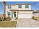 Two-story home with a paved driveway and landscaped lawn at 101 Runaway Field Ave, Nokomis, FL 34275