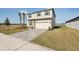 Two-story house with a white exterior, gray brick driveway, and a large grassy yard at 101 Runaway Field Ave, Nokomis, FL 34275