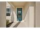 Inviting teal front door entrance with a glass panel at 101 Runaway Field Ave, Nokomis, FL 34275