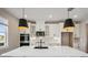 Modern kitchen with white cabinets, white quartz countertops and black accents at 101 Runaway Field Ave, Nokomis, FL 34275