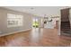 Open living room and kitchen area with wood-look tile floors at 101 Runaway Field Ave, Nokomis, FL 34275