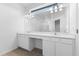 Double vanity bathroom with white cabinets and quartz countertop at 9572 Vibrant Lane, Venice, FL 34292