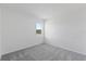 Bright bedroom with neutral carpet, a window, and simple, clean design at 9572 Vibrant Lane, Venice, FL 34292