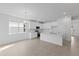 White kitchen with island and stainless steel appliances at 9572 Vibrant Lane, Venice, FL 34292