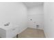 Laundry room with utility sink and overhead shelving at 9572 Vibrant Lane, Venice, FL 34292