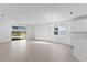 Bright living room with sliding doors to backyard and pond view at 9572 Vibrant Lane, Venice, FL 34292