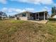 Home's back exterior showcasing a screened patio at 272 Algiers Dr, Venice, FL 34293