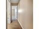 Hallway with wood-look floors leading to bedrooms at 272 Algiers Dr, Venice, FL 34293