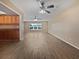 Spacious living room with wood-look floors and ceiling fans at 272 Algiers Dr, Venice, FL 34293