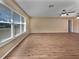 Living room with wood-look floors and large window at 272 Algiers Dr, Venice, FL 34293