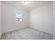 Bright bedroom with neutral carpeting and window at 37488 Williamette Way, Zephyrhills, FL 33540