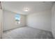 Bright bedroom featuring grey carpet and large window at 37488 Williamette Way, Zephyrhills, FL 33540