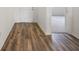 Bright foyer with wood-look flooring and doors leading to other rooms at 37488 Williamette Way, Zephyrhills, FL 33540