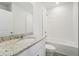 Clean bathroom with a shower/tub combo, granite countertop, and white cabinets at 396 Lazy Shore Dr, Nokomis, FL 34275