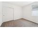 Simple bedroom with neutral carpeting and double sliding doors at 396 Lazy Shore Dr, Nokomis, FL 34275