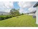 Spacious backyard with lush lawn and privacy hedge at 428 Lazy Shore Dr, Nokomis, FL 34275