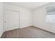 Bright bedroom with neutral walls, carpet, and double door closet at 428 Lazy Shore Dr, Nokomis, FL 34275