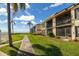 Condo building exterior showcasing waterfront location and landscaping at 6268 Palma Del Mar S Blvd # 204, St Petersburg, FL 33715