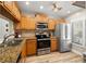 Well-equipped kitchen featuring wood cabinets and granite counters at 6268 Palma Del Mar S Blvd # 204, St Petersburg, FL 33715