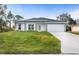 Newly constructed home with a green lawn and driveway at 3486 Shawn St, Port Charlotte, FL 33980