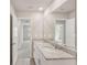 Modern bathroom features double vanity with granite countertop and white cabinetry at 14009 Crutchfield Ct, Parrish, FL 34219