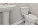Bathroom featuring a pedestal sink and toilet with neutral wall color at 14009 Crutchfield Ct, Parrish, FL 34219