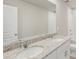 Modern bathroom features double vanity with granite countertop and white cabinetry at 14009 Crutchfield Ct, Parrish, FL 34219