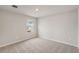 This bedroom has neutral walls and carpet, and a window to let in natural light at 14009 Crutchfield Ct, Parrish, FL 34219