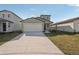 Charming single-Gathering home featuring a two-car garage, modern design, and freshly landscaped front yard at 14009 Crutchfield Ct, Parrish, FL 34219