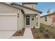 Front entrance of a modern home, featuring a sleek door, manicured landscaping, and inviting walkway at 14009 Crutchfield Ct, Parrish, FL 34219
