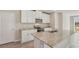Bright kitchen featuring white cabinets, stainless steel appliances, and granite countertops at 14009 Crutchfield Ct, Parrish, FL 34219
