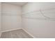 An empty walk-in closet features neutral walls and carpet, with a wire shelf for storage at 14009 Crutchfield Ct, Parrish, FL 34219