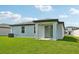 Covered patio with sliding glass doors leading to a grassy backyard at 156 Lazy Shore Dr, Nokomis, FL 34275