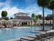 Resort-style pool with cabana, lounge chairs, and umbrellas at 156 Lazy Shore Dr, Nokomis, FL 34275