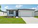 One-story home with white exterior, gray roof, and a two-car garage at 156 Lazy Shore Dr, Nokomis, FL 34275