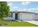 One-story home with white exterior, gray roof, and a two-car garage at 156 Lazy Shore Dr, Nokomis, FL 34275