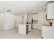 Modern kitchen with white cabinets, stainless steel appliances, and an island at 156 Lazy Shore Dr, Nokomis, FL 34275