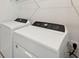Laundry room with side-by-side Whirlpool washer and dryer at 156 Lazy Shore Dr, Nokomis, FL 34275