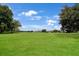 View of a lush green golf course with homes in the background at 13213 Palmilla Cir, Dade City, FL 33525