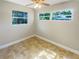 Well-lit bedroom with tile floors and two windows at 4185 Barracuda Se Dr, St Petersburg, FL 33705