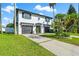 Two-story house featuring a white exterior and lush lawn at 307 161St Ave, Redington Beach, FL 33708