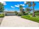 Bright white house with a two-car garage and lush landscaping at 200 Colony Point S Rd, St Petersburg, FL 33705